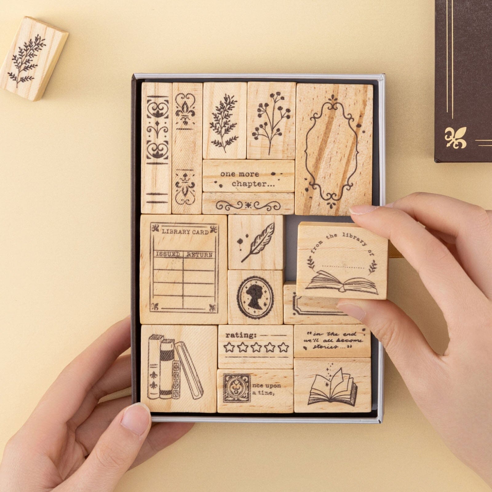 Hand taking out ‘from the library of’ rubber stamp from Our Stories stamp set