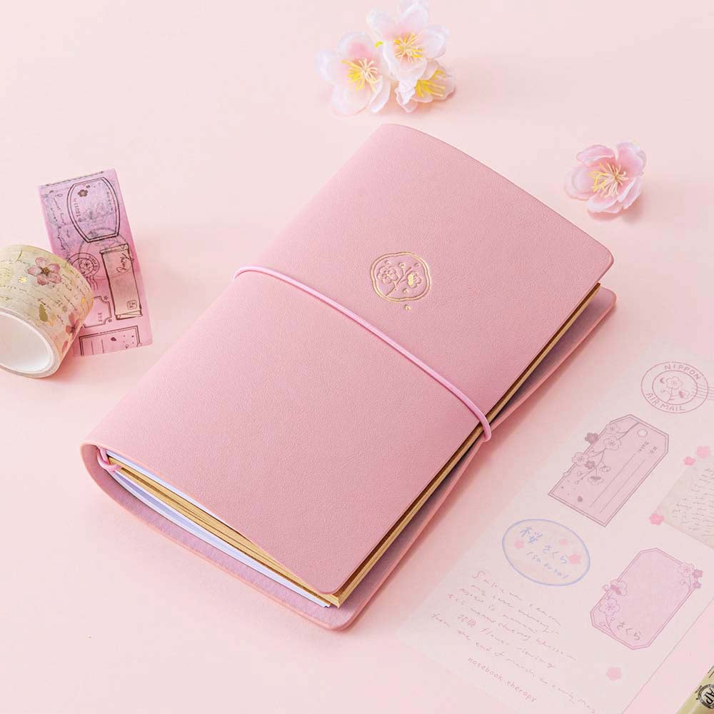 Tsuki ‘Sakura Journey’ Limited Edition Travel Notebook with Tsuki ‘Sakura Journey’ Vintage Journey Washi Tape Set with cherry blossoms on pink background