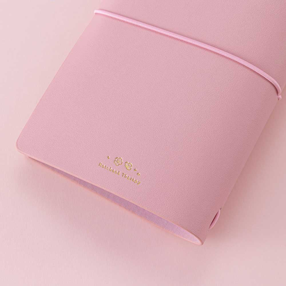 Close up of back cover of Tsuki ‘Sakura Journey’ Limited Edition Travel Notebook on pink background