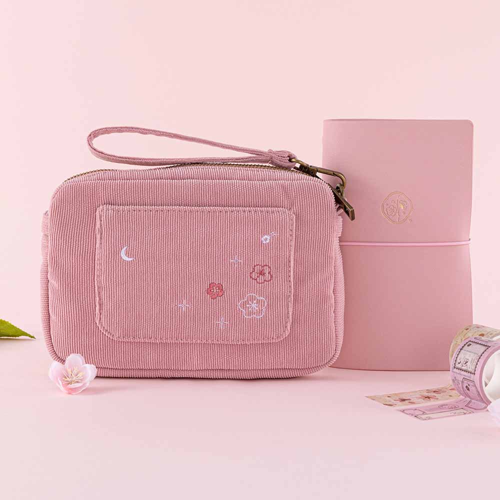 Tsuki ‘Sakura Journey’ Travel Pouch with Tsuki ‘Sakura Journey’ Limited Edition Travel Notebook and pens inside with Tsuki ‘Sakura Journey’ Vintage Journal Washi Tape Set with cherry blossoms in pink background