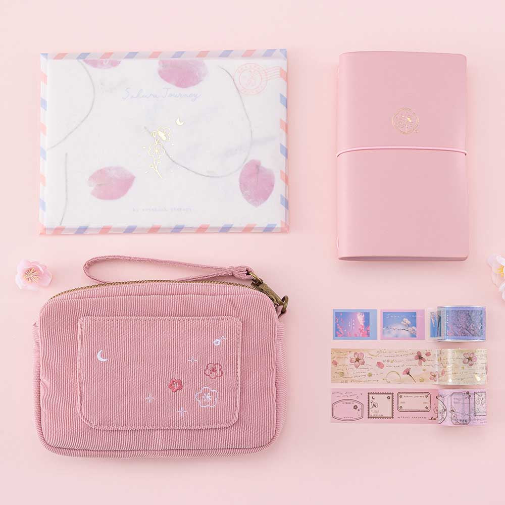 Tsuki ‘Sakura Journey’ Vintage Journal Washi Tape Set with Tsuki ‘Sakura Journey’ Limited Edition Travel Notebook and Tsuki ‘Sakura Journey’ Scrapbooking Set’ and Tsuki ‘Sakura Journey’ Travel Pouch with cherry blossoms on pink background