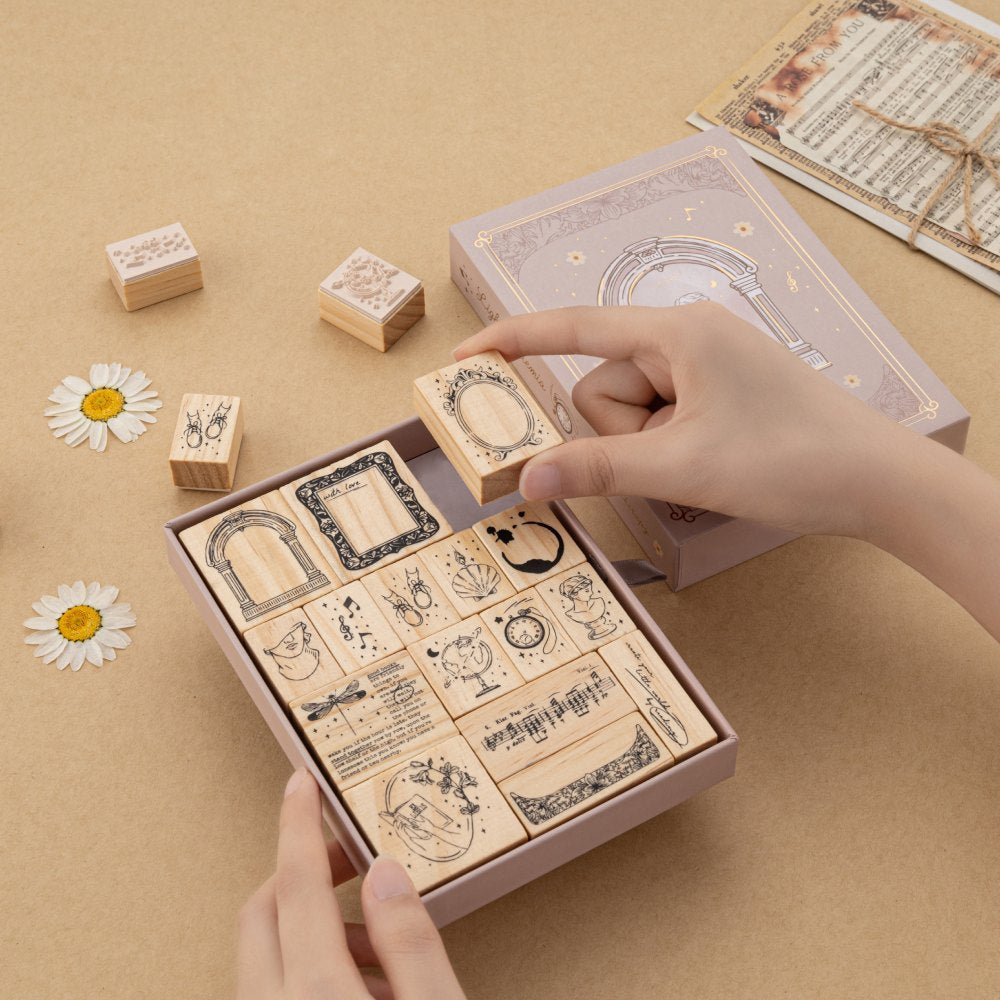 Hand picking up mirror bullet journal stamp from the Light Academia bullet journal stamp set