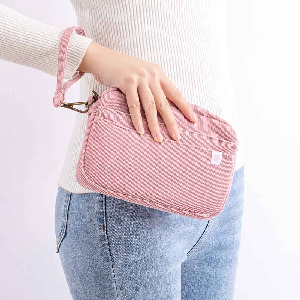 Tsuki ‘Sakura Journey’ Travel Pouch held in hand by woman in white background