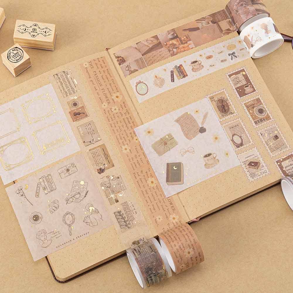 Tsuki Light Academia washi tape on kraft paper bullet journal with wooden stamps in the background
