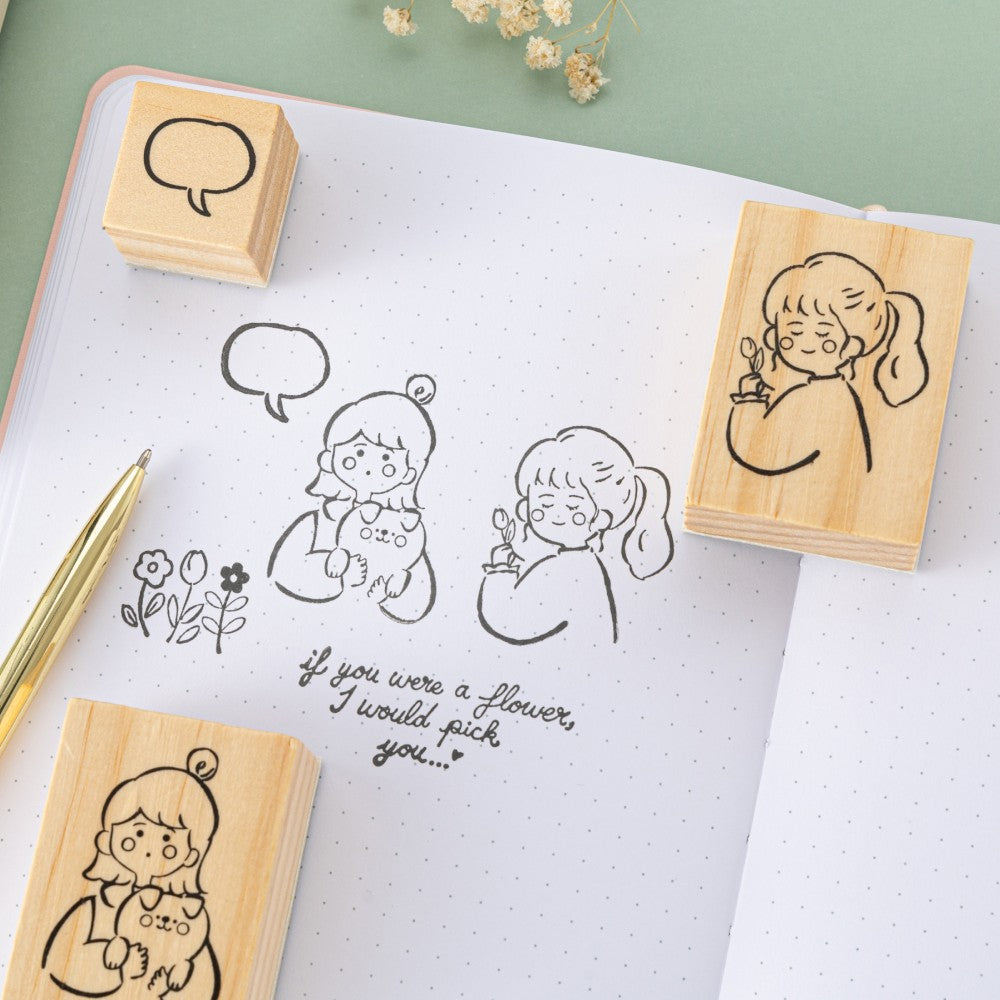 Girl stamps with speech bubble and text that says “if you were a flower I would pick you” on bullet journal page