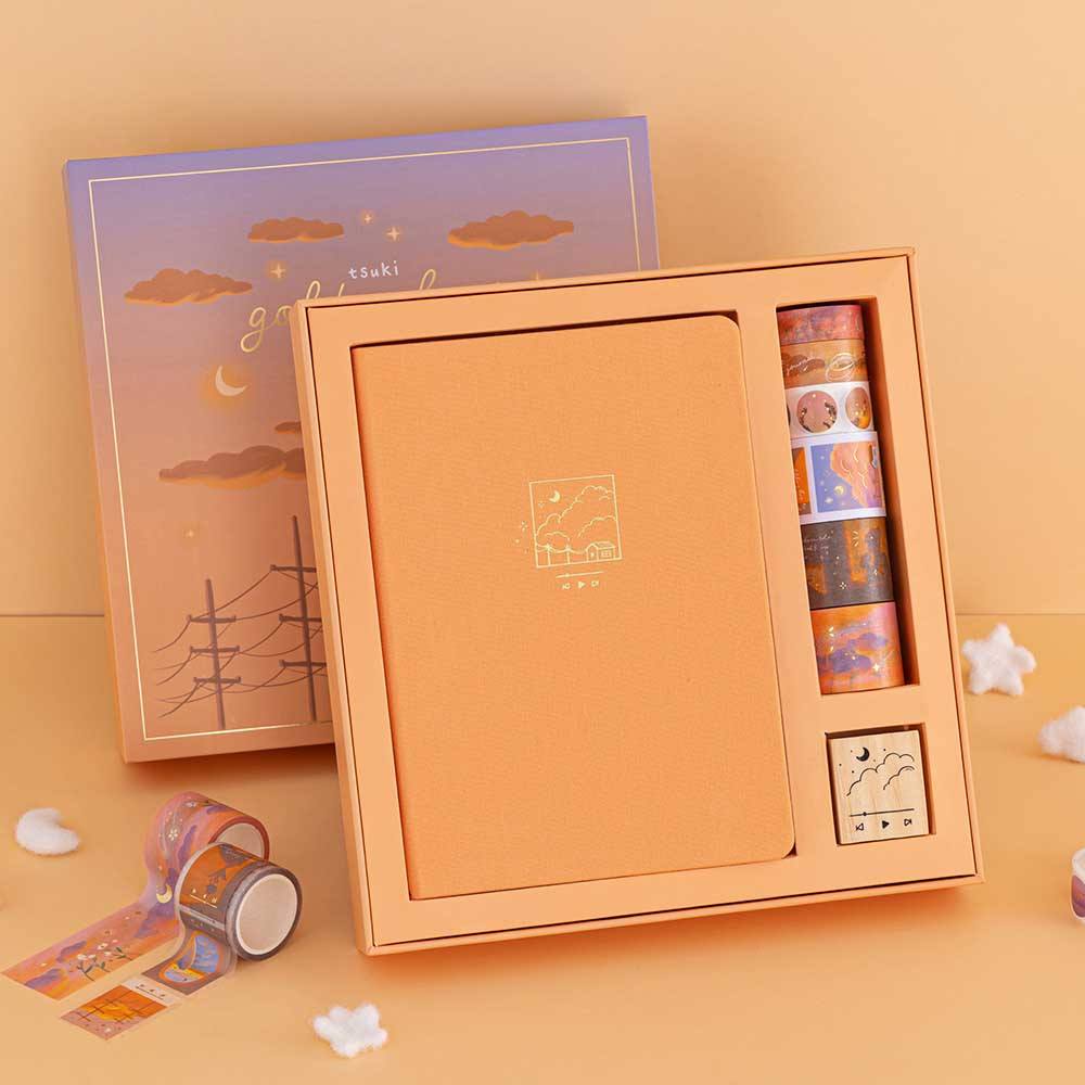 Tsuki Golden Hour Bullet Journal Box Set opened box standing upright against an orange wall