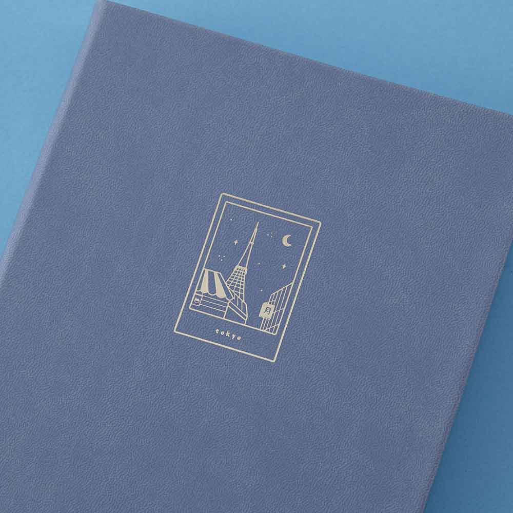 Close-up of the gold foil details on the blue vegan leather notebook