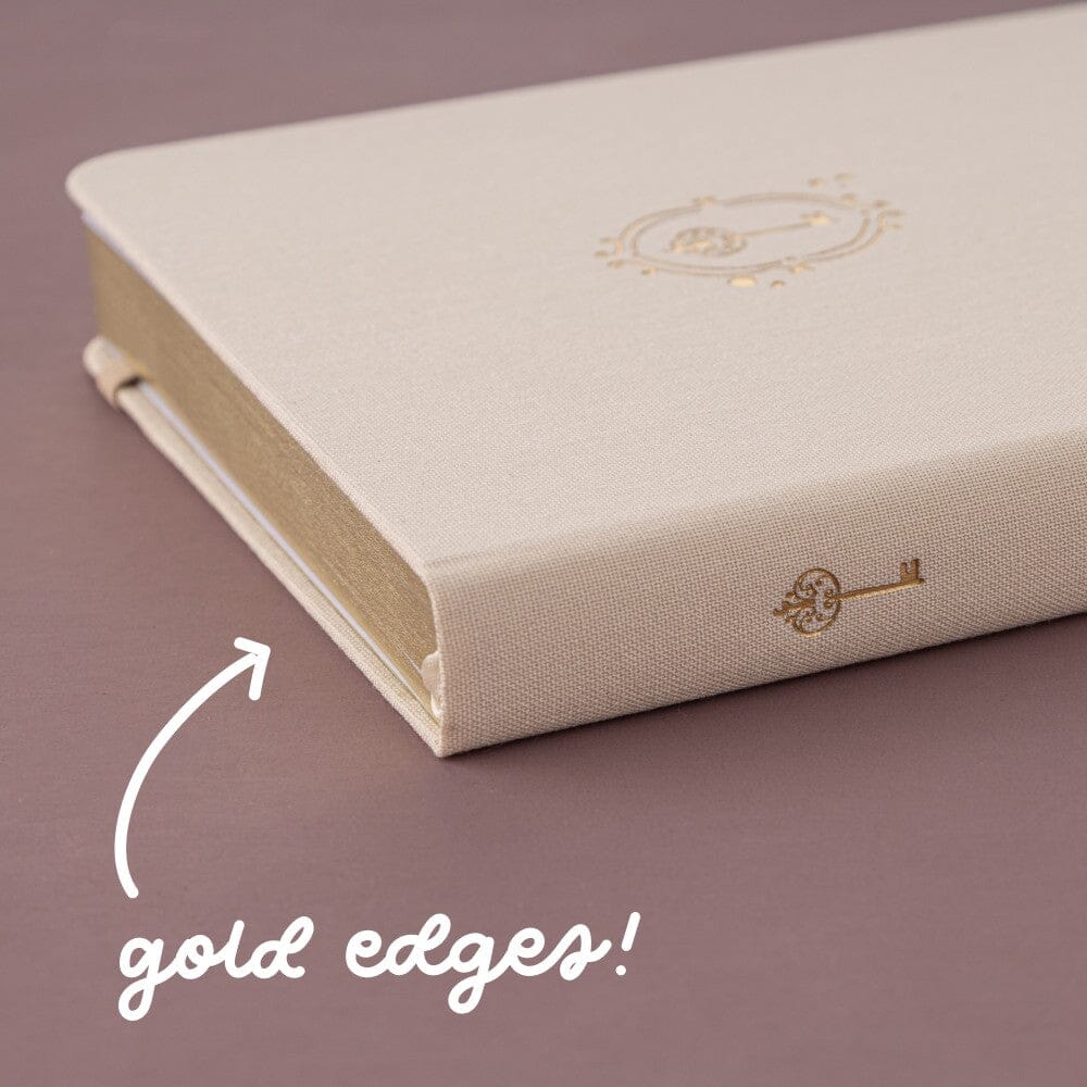 Gold paper edges and gold key detail on the spine of Love Lock bullet journal notebook