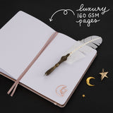 Hand opening the back pocket of Tsuki Moonlit Dusk Bullet Journal with rose gold moon-shaped paperclip inside