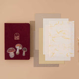 Tsuki Mixed Scrapbook Paper Pack with free mushroom stickers and Tsuki ‘Kinoko’ Limited Edition Bullet Journal on beige background