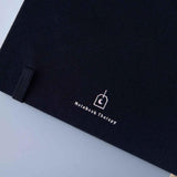 Close up of back page cover of Tsuki ‘Cup of Galaxy’ Limited Edition Holographic Bullet Journal on light blue background