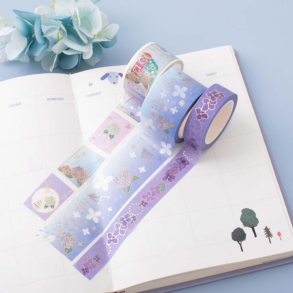 Close up of Tsuki Endless Summer Washi Tape Set on open bullet journal page with light blue hydrangea flowers on light blue background