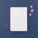 Back cover of Tsuki ‘Winter Journey’ Limited Edition Bullet Journal with free paperclip gift on navy background