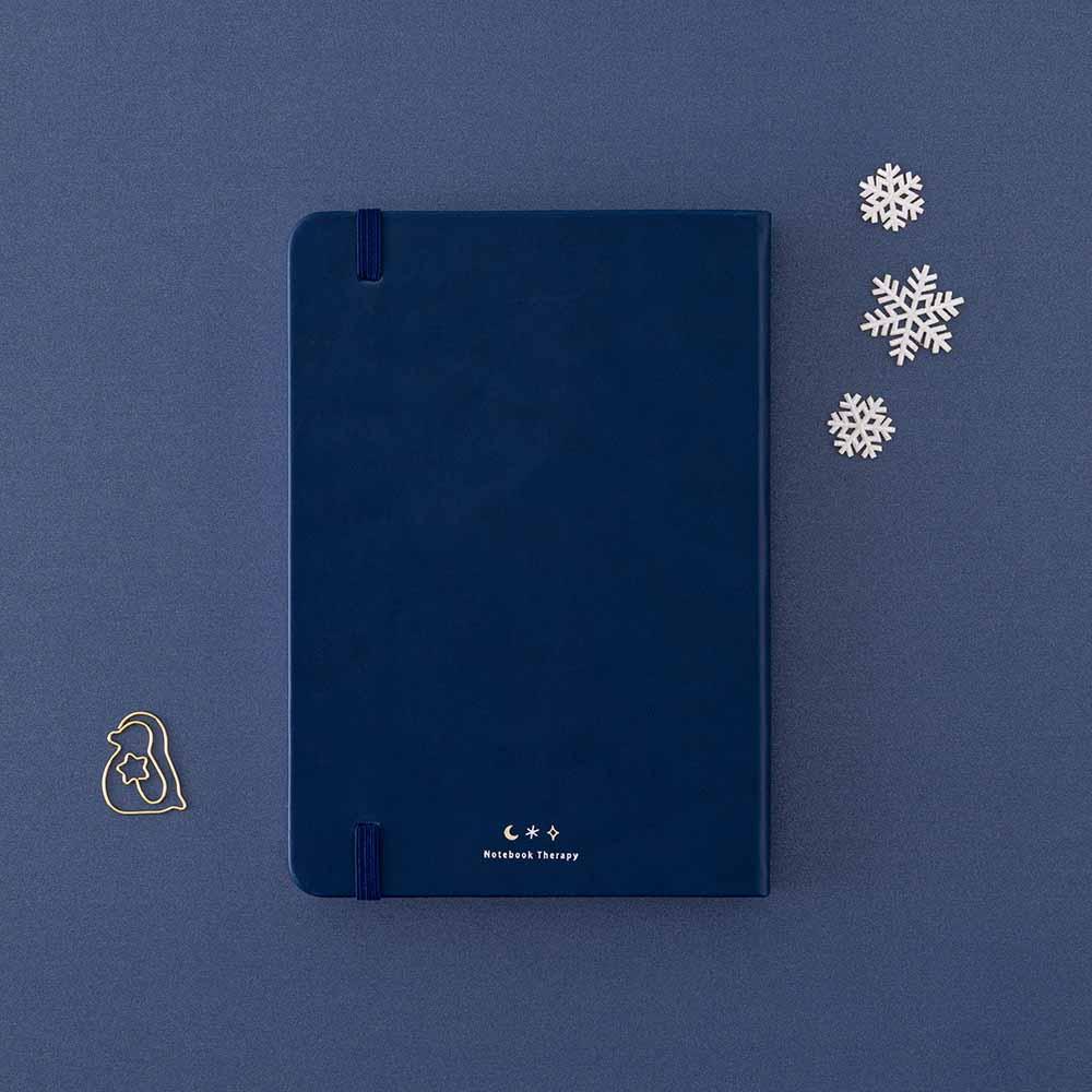 Back cover of Tsuki ‘Winter Wishes’ Limited Edition Bullet Journal with free paperclip gift on navy background