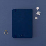 Back cover of Tsuki ‘Winter Wishes’ Limited Edition Bullet Journal with free paperclip gift on navy background