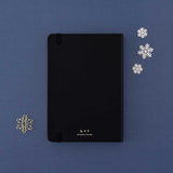 Back cover of Tsuki ‘Winter Journey’ Limited Edition Bullet Journal with free paperclip gift on navy background