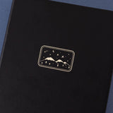 Close up of the front cover of Tsuki ‘Winter Journey’ Limited Edition Bullet Journal on navy background