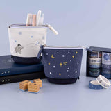 Tsuki ‘Dreams of Snow’ Pop-Up Pencil Cases in Starry Night and Playful Penguin on Tsuki ‘Winter Wishes’ Limited Edition Bullet Journal and Tsuki ‘Winter Journey’ Limited Edition Bullet Journal and with Tsuki ‘Dreams of Snow’ Bullet Journal Stamps with Tsuki ‘Dreams of Snow’ Holographic Washi Tape Set in light blue background