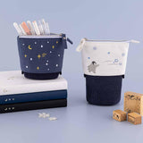 Tsuki ‘Dreams of Snow’ Pop-Up Pencil Cases in Starry Night and Playful Penguin on Tsuki ‘Winter Wishes’ Limited Edition Bullet Journal and Tsuki ‘Winter Journey’ Limited Edition Bullet Journal and Tsuki ‘Suzume’ Winter Limited Edition Bullet Journal with Tsuki ‘Dreams of Snow’ Bullet Journal Stamps with snowflakes in light blue background