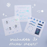 Three free stickers sheets from Tsuki ‘Dreams of Snow’ Holographic Washi Tape Set on light blue background