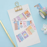 Close up of Tsuki ‘Four Seasons’ Washi Tapes by Notebook Therapy x Milkkoyo on white card clipboard with gold pen and white flower on light blue background
