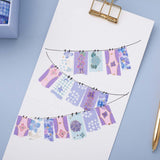 Tsuki Endless Summer Washi Tape Set in bunting pattern on white clipboard on light blue background
