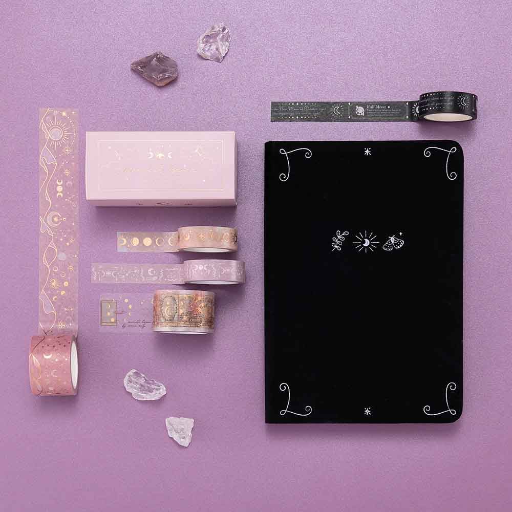 Tsuki ‘Moonlit Blush’ Washi Tape Set with Tsuki ‘Moonlit Spells’ Washi Tapes and Tsuki ‘Moonlit Spell’ Limited Edition Holographic Bullet Journal and amethyst stones on purple background