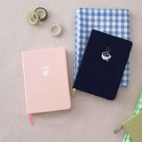 Tsuki ‘Ichigo’ Limited Edition Boba Bullet Journal and Tsuki ‘Cup of Galaxy’ Limited Edition Holographic notebook and Tsuki ‘Matcha Ichigo’ Washi Tapes on blue gingham tablecloth on beige linen covered table