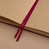 Close up of open page spread of Tsuki Kraft Paper Limited Edition Bullet Journal in Kinoko with two bookmark ribbons on beige background