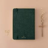 Back cover of Tsuki ‘Midnight Garden’ Limited Edition Bullet Journal with free paperclip gift and dried flowers on beige background
