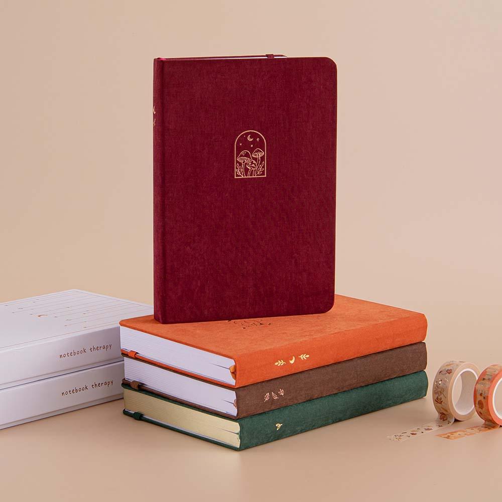 Tsuki ‘Kinoko’ Limited Edition Bullet Journal with Tsuki ‘Kitsune’ Limited Edition Fox bujo with Tsuki ‘Midnight Garden’ Limited Edition bullet journal and Tsuki ‘Kitsune’ Limited Edition notebook and Tsuki ‘Nara’ Limited Edition Bullet Journal with eco-friendly gift boxes with Tsuki ‘Maple Dreams’ Washi Tapes on beige background