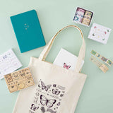 Tsuki ‘Flutter + Dream’ Tote Bag by Notebook Therapy x Pelinkan with Tsuki Teal Sky ‘Flutter + Dream’ Limited Edition Bullet Journal by Notebook Therapy x Pelinkan and Tsuki Cloud White ‘Flutter + Dream’ Limited Edition Bullet Journal by Notebook Therapy x Pelinkan and Tsuki ‘Flutter + Dream’ Washi Tapes by Notebook Therapy x Pelinkan and Tsuki ‘Flutter + Dream’ Bullet Journal Stamps by Notebook Therapy x Pelinkan on mint background