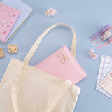 Tsuki ‘Sakura Journey’ Notebook Pouch inside canvas tote bag with Tsuki ‘Sakura Journey’ Bullet Journal Stamp Set and Tsuki ‘Sakura Journey’ Limited Edition Bullet Journal and Tsuki ‘Sakura Journey’ Washi Tapes with gingham envelopes and cherry blossoms on light blue background
