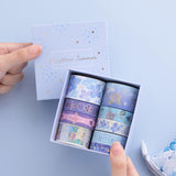 Tsuki Endless Summer Washi Tape Set with eco-friendly gift box packaging held in hands with Tsuki Endless Summer Pop Up Pencil case in petal blue on light blue background