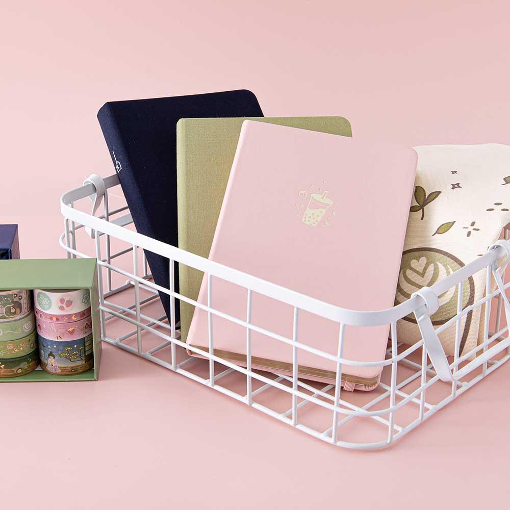 Tsuki Tea Party Collection with Tsuki ‘Matcha Matcha’ Tote Bag and Tsuki ‘Matcha Matcha’ Limited Edition Bullet Journal and Tsuki ‘Matcha Ichigo’ Washi Tape Set and Tsuki ‘Ichigo’ Limited Edition Boba Bullet Journal and Tsuki ‘Cup of Galaxy’ Limited Edition Holographic Bullet Journal in white basket in light pink background