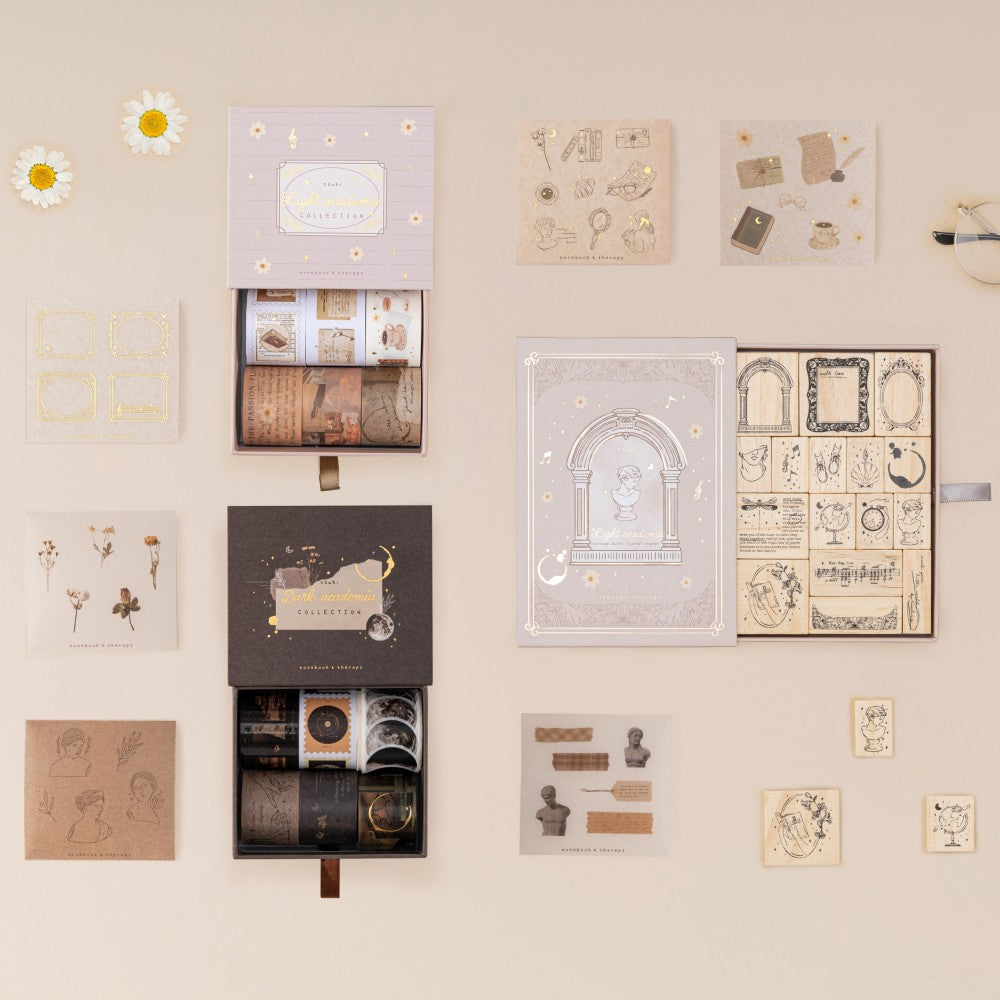 Tsuki Academia collection flatlay including Dark Academia washi tape set, Light Academia bullet journal stamp set, Light Academia washi tape set