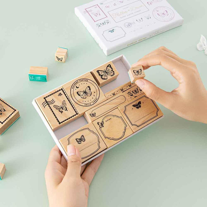 Tsuki ‘Flutter + Dream’ Bullet Journal Stamp Set by Notebook Therapy x Pelinkan held in hands in mint background