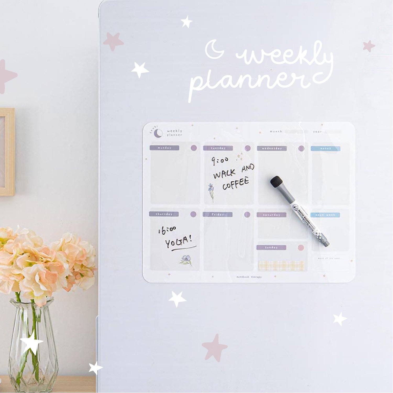 Tsuki Reusable Weekly Planner with dry erase marker on fridge surface with flowers