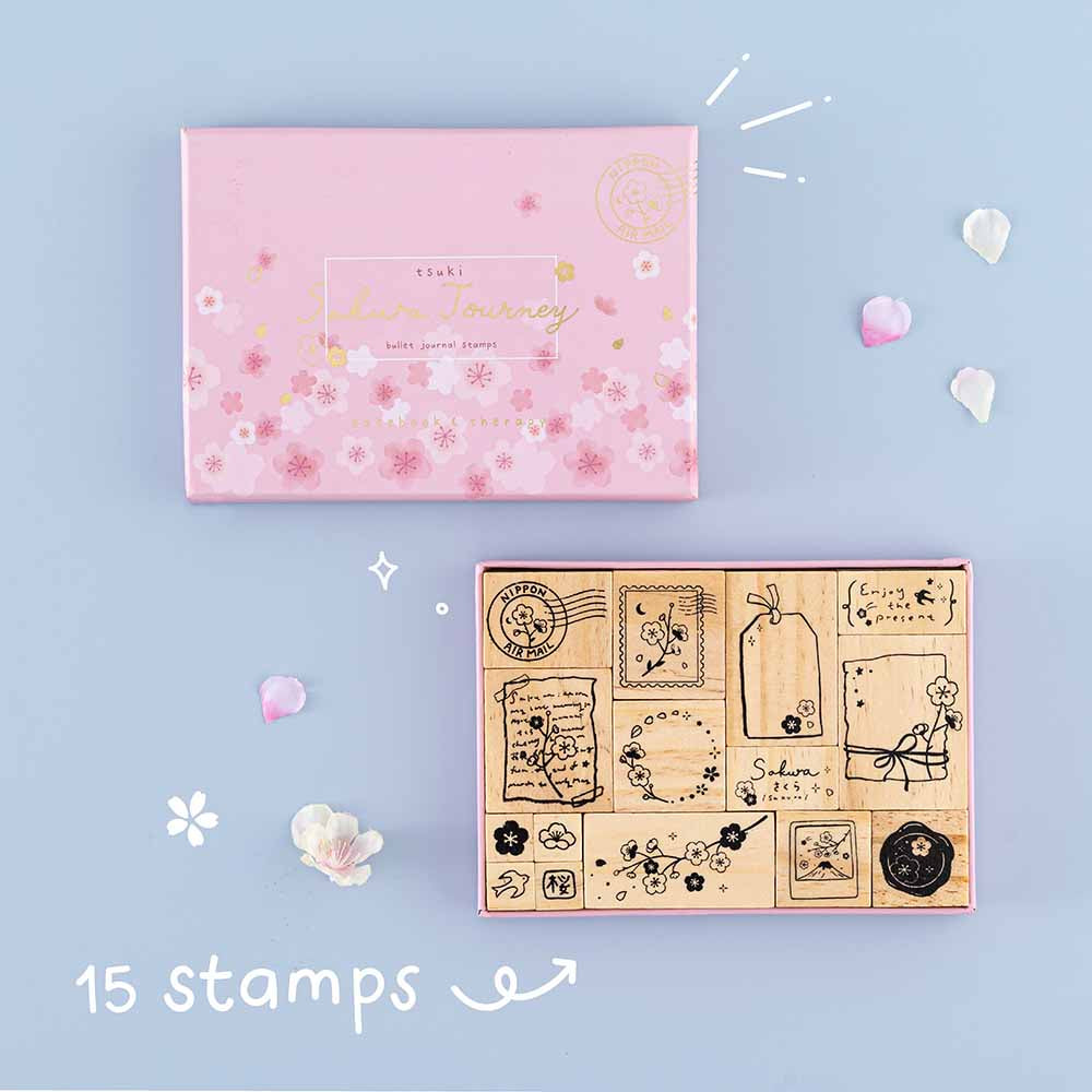 Tsuki ‘Sakura Journey’ Bullet Journal Stamp Set with fifteen stamps with cherry blossom petals on light blue background