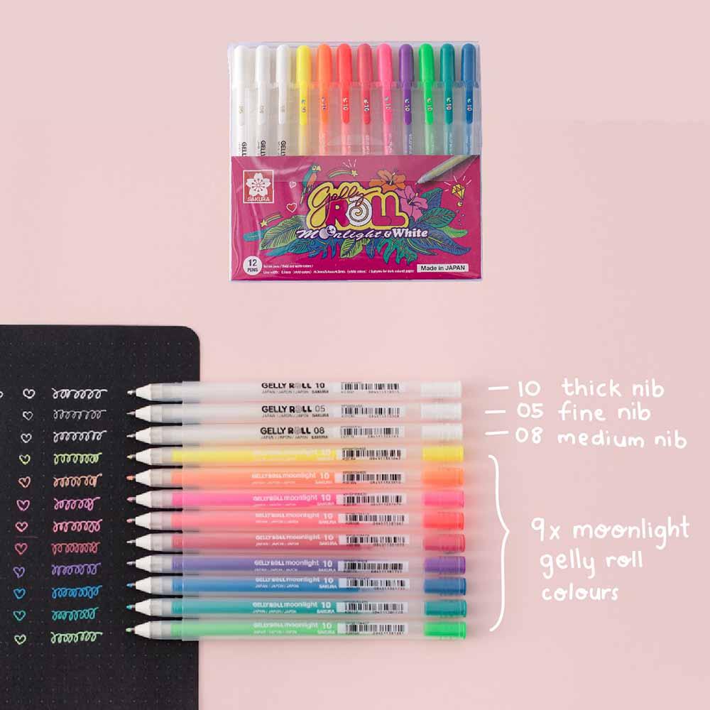 Moonlight Gelly Roll Pens in various colours on open black page bullet journal paper on baby pink background