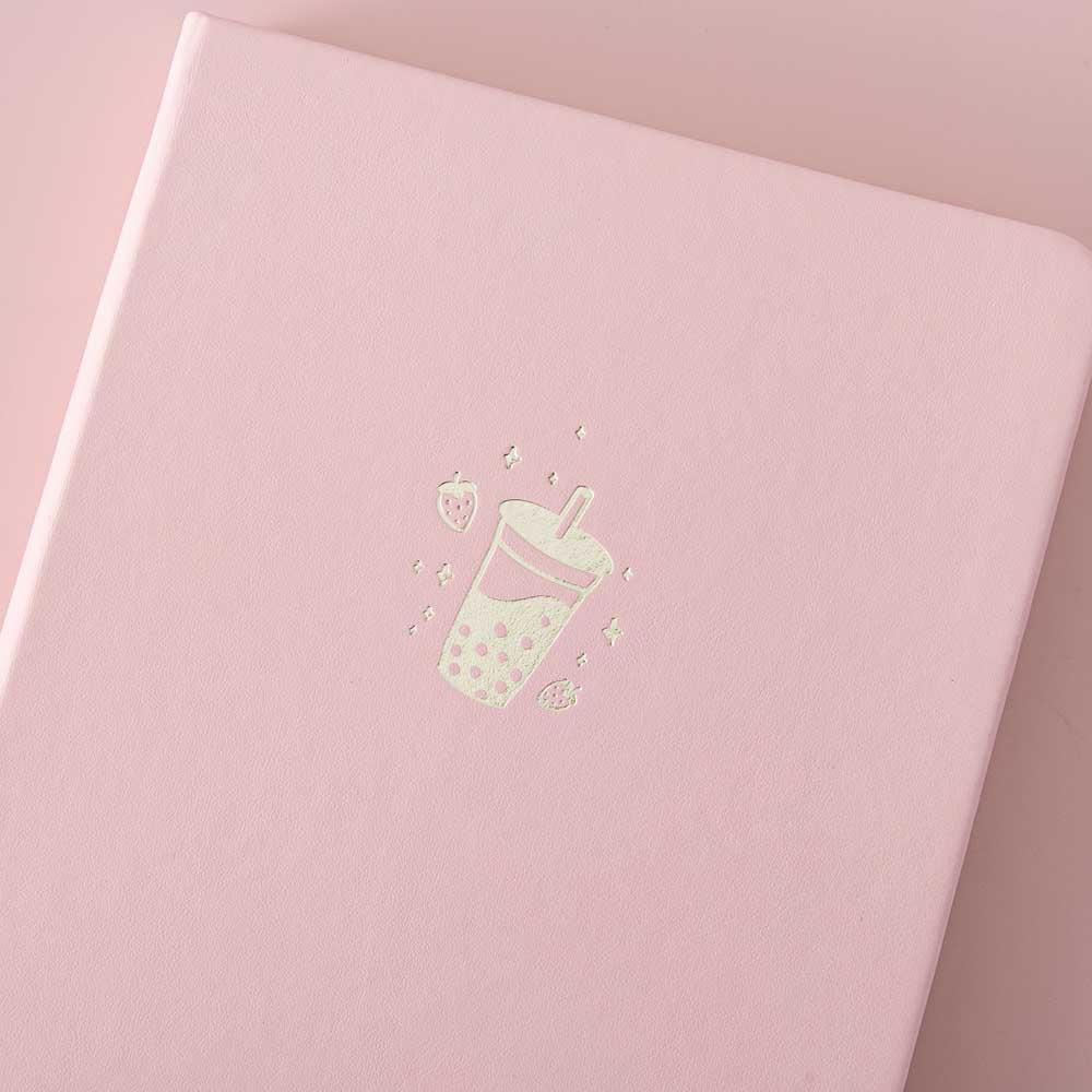 Close up of the front cover of Tsuki ‘Ichigo’ Limited Edition Boba Bullet Journal on light pink background
