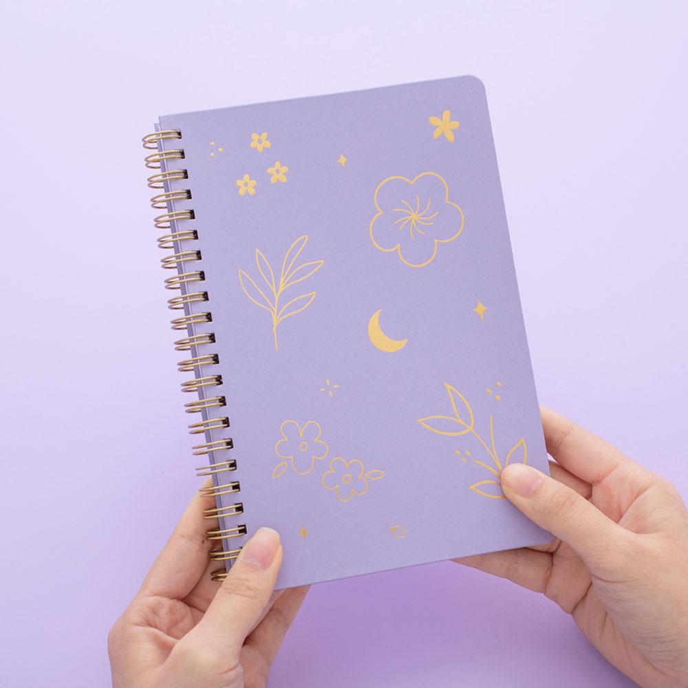 Tsuki lilac taro floral ringbound notebook held in hands in lilac background
