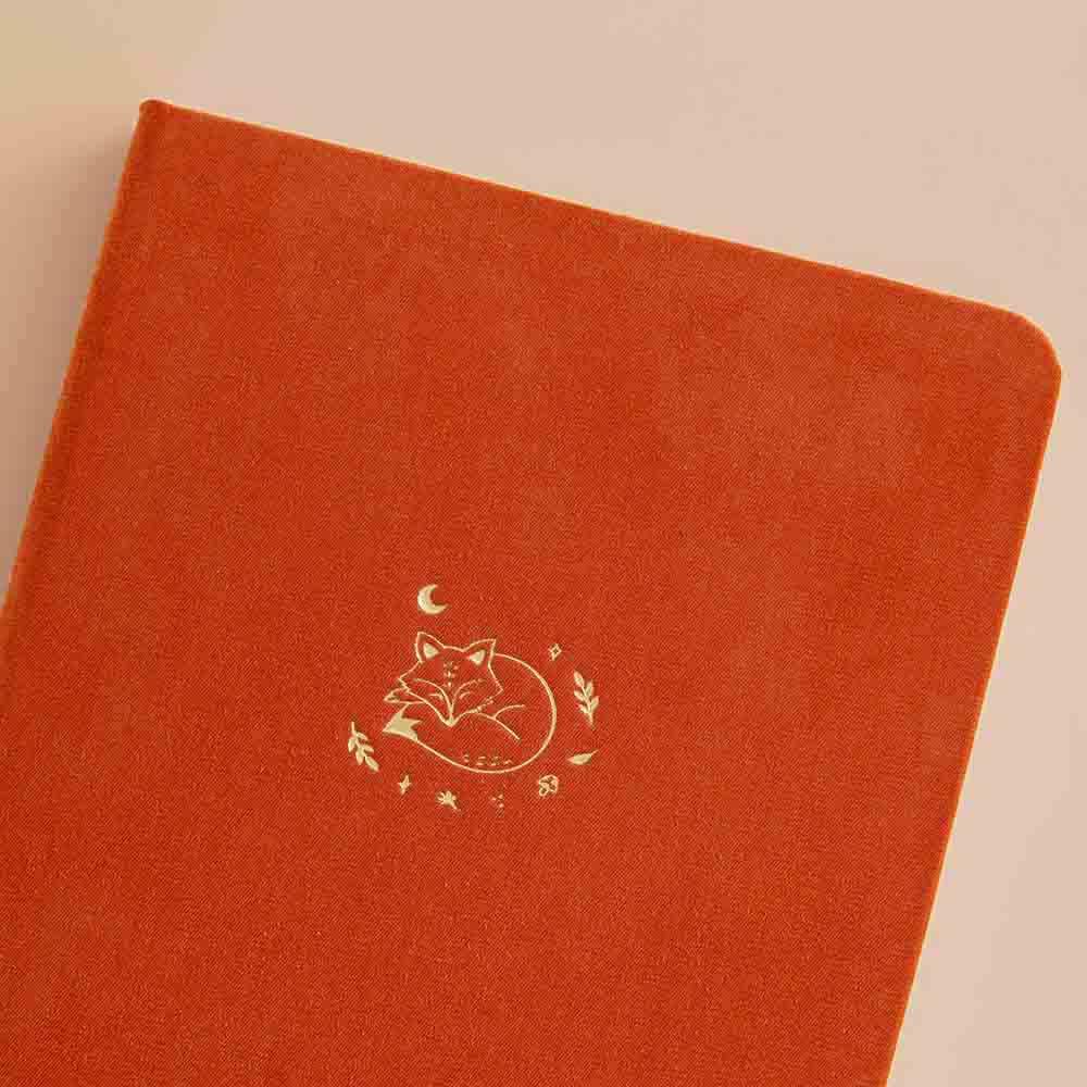 Close up of the front cover of Tsuki ‘Kitsune’ Limited Edition Fox Bullet Journal on beige background