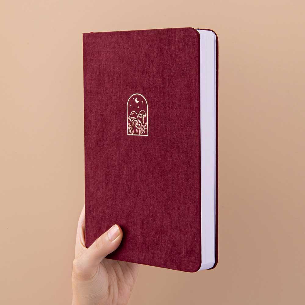 Tsuki ‘Kinoko’ Limited Edition Bullet Journal held in hand at spine angle in beige background