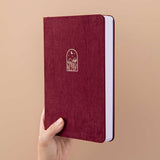 Tsuki ‘Kinoko’ Limited Edition Bullet Journal held in hand at spine angle in beige background