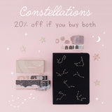 Flatlay of black constellations bullet journal and washi tape set with the words “constellations 20% off if you buy both”