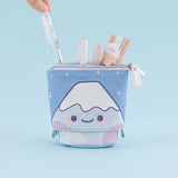 Tsuki ‘Four Seasons’ Fuji Pop-Up Pencil Case by Notebook Therapy x Milkkoyo with pens inside held in hand in light blue background