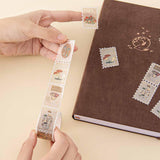 Close up of Tsuki ‘Maple Dreams’ Stamp Washi Tape held in hands with Tsuki ‘Nara’ Limited Edition Bullet Journal on cream background