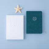 Tsuki sea green velvet Dolphin Days notebook with eco-friendly box packaging and starfish on blue background
