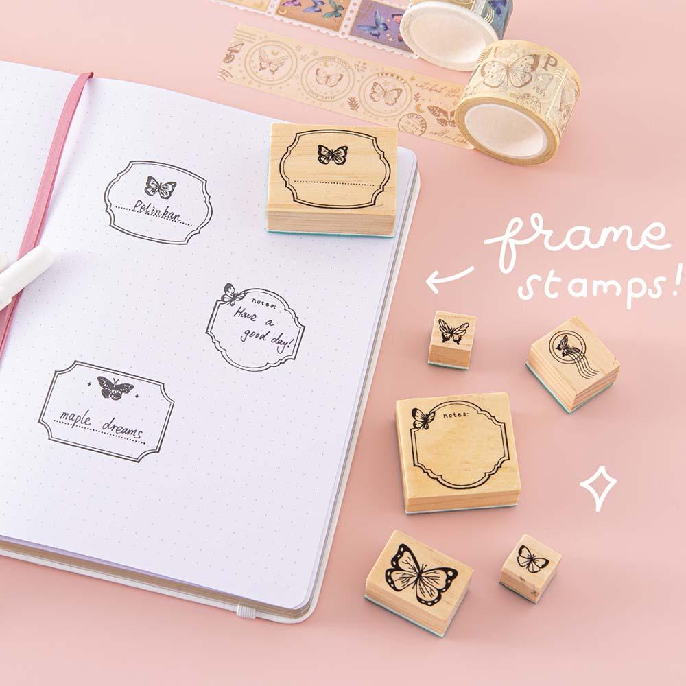 Tsuki ‘Flutter + Dream’ Bullet Journal Stamp Set by Notebook Therapy x Pelinkan with frame stamps on open Tsuki Cloud White ‘Flutter + Dream’ Limited Edition Bullet Journal by Notebook Therapy x Pelinkan with Tsuki ‘Flutter + Dream’ Washi Tape Set by Notebook Therapy x Pelinkan on pastel pink background